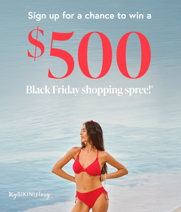 Woman posing by the water, gazing into the distance while adjusting her sunglasses and wearing a red eyelet-embroidered bikini set from the brand My Bikini Story.