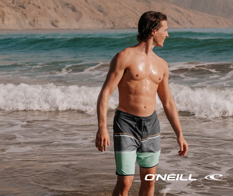 Men wearing an O’Neill boardshort with grey, blue, and yellow stripes on a graphite grey base.