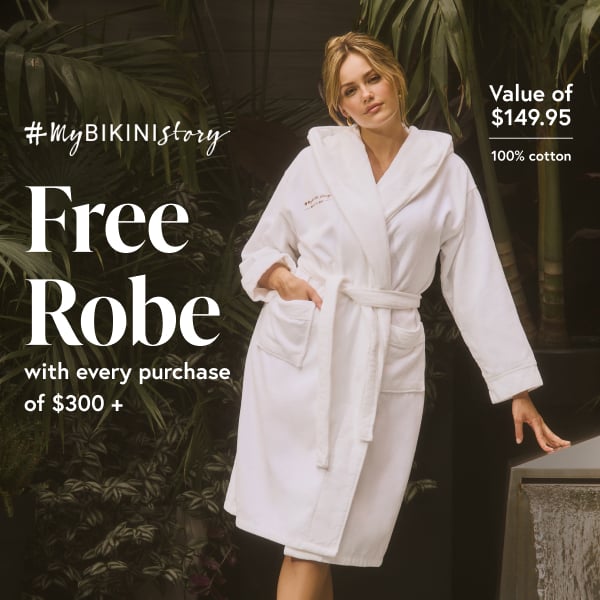 Woman wearing a white robe from the brand #MyBikiniStory made from cotton.