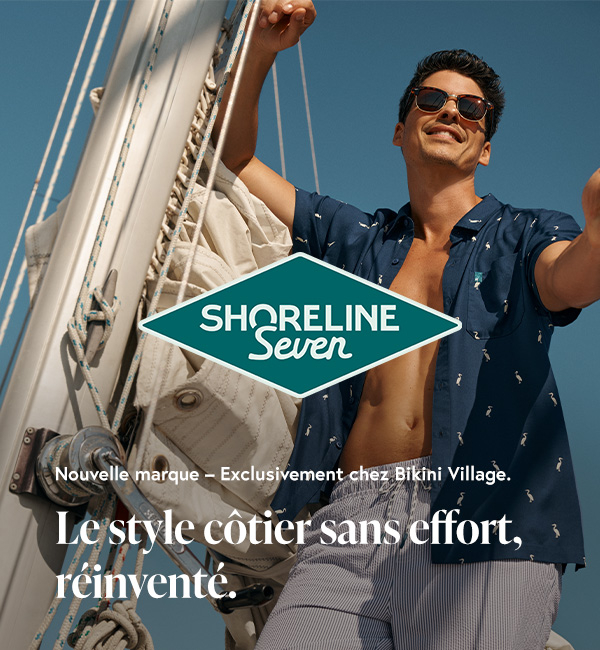 Homme à bord d’un voilier, vêtu d’un maillot volley et d’une chemise Shoreline Seven.