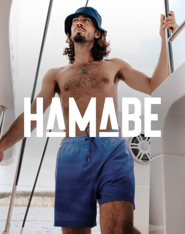 &nbsp;Man on a boat wearing blue gradient volley swim shorts from Hamabe.