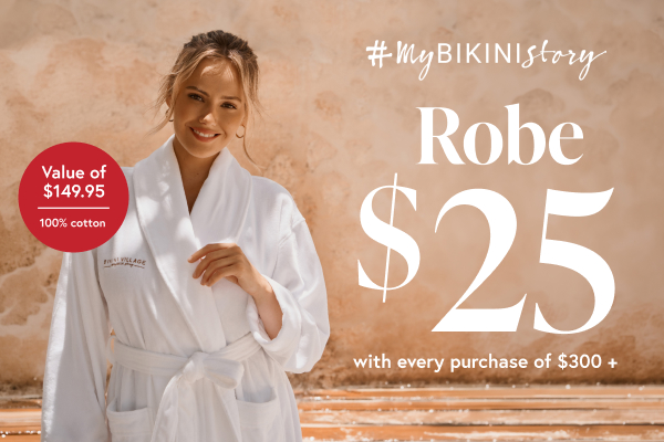 Woman wearing a white robe from Bikini Village.
