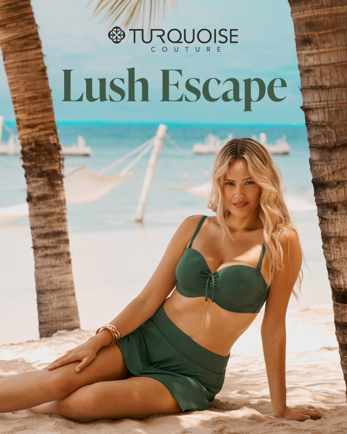 A woman sitting on the sand beneath palm trees, wearing a green Turquoise Couture bikini set.