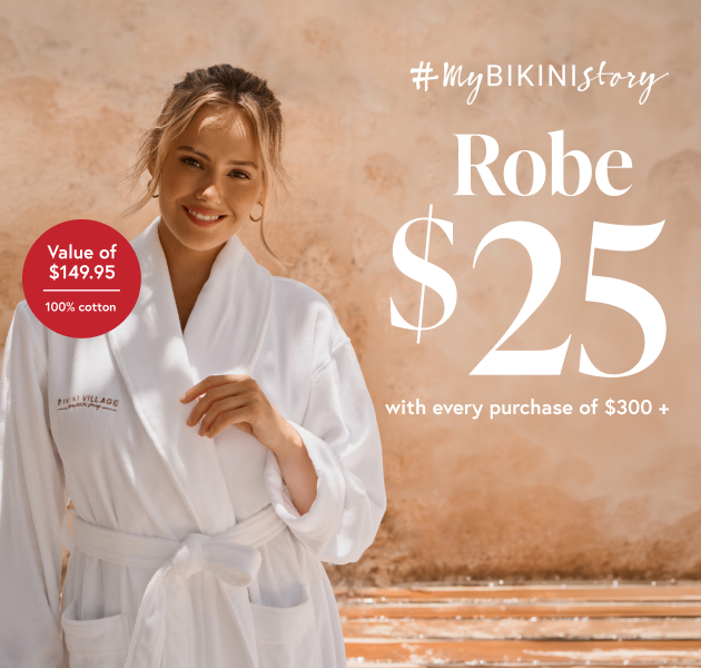 Woman wearing a white robe from Bikini Village.