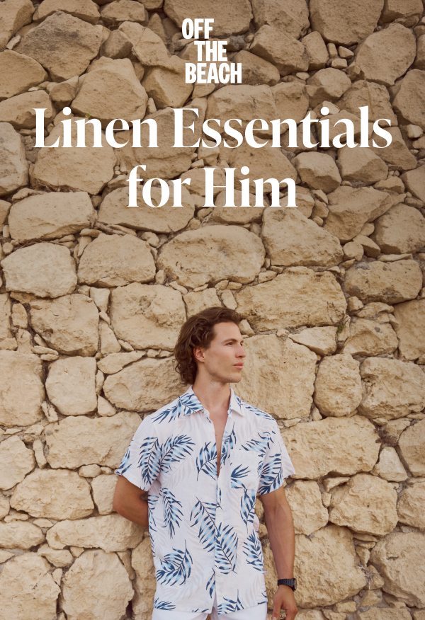 A man standing against a rock wall, wearing an Off The Beach linen outfit.	
