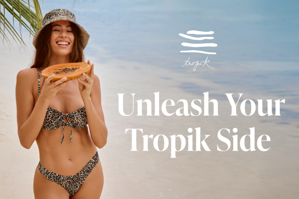 Woman wearing a leopard-print bikini from Tropik, holding a papaya.	