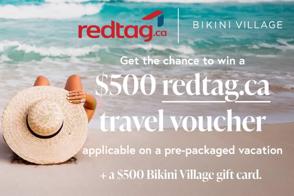 A woman lying on the beach wearing a sun hat. 