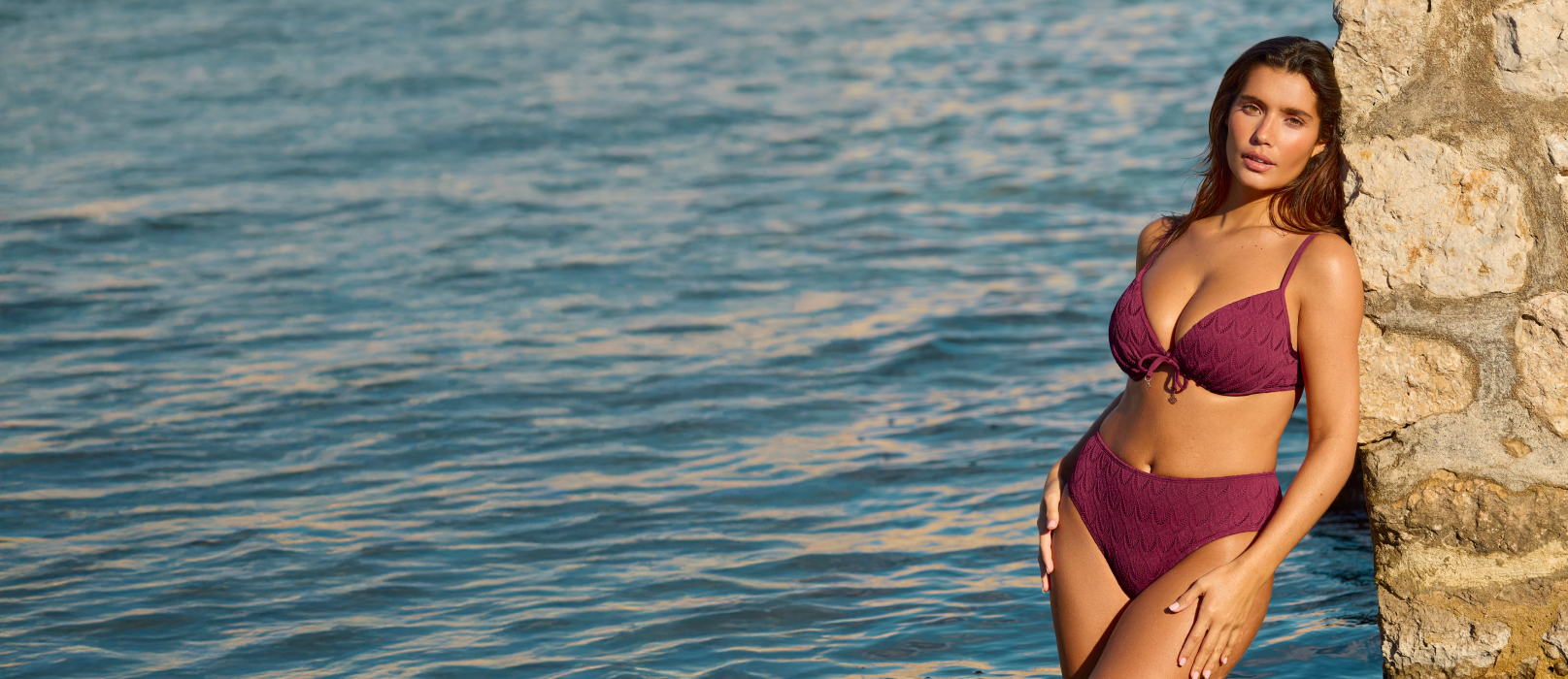 Femme portant un bikini prune profond de la marque Turquoise Couture, affichant une allure &eacute;l&eacute;gante et assur&eacute;e. 