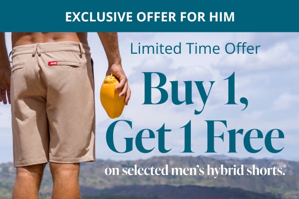 Man with his back to the camera, looking at the horizon and wearing beige hybrid shorts from Hamabe 