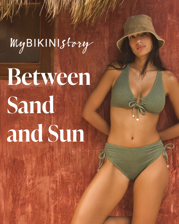 A woman leaning against a wall wearing a khaki green crochet bikini set by My Bikini Story. 