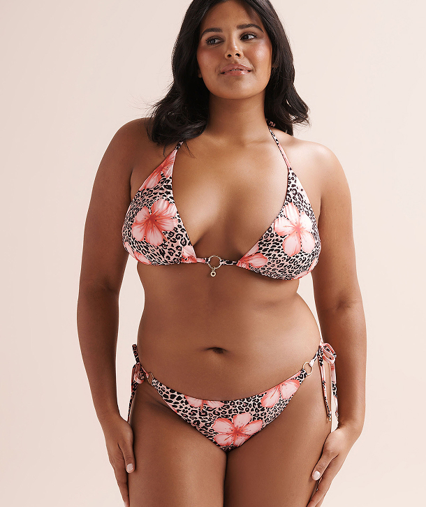 Woman wearing a leopard‑floral bikini set by the brand Seatonic.