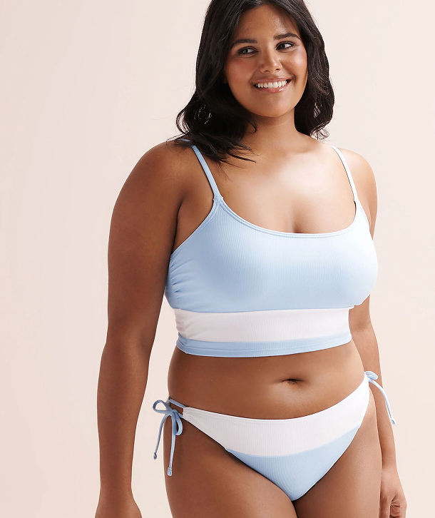 Woman wearing a color‑block bikini set by the brand Tropik. 
