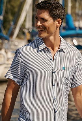 Man wearing a striped shirt from the brand Shoreline Seven. 
