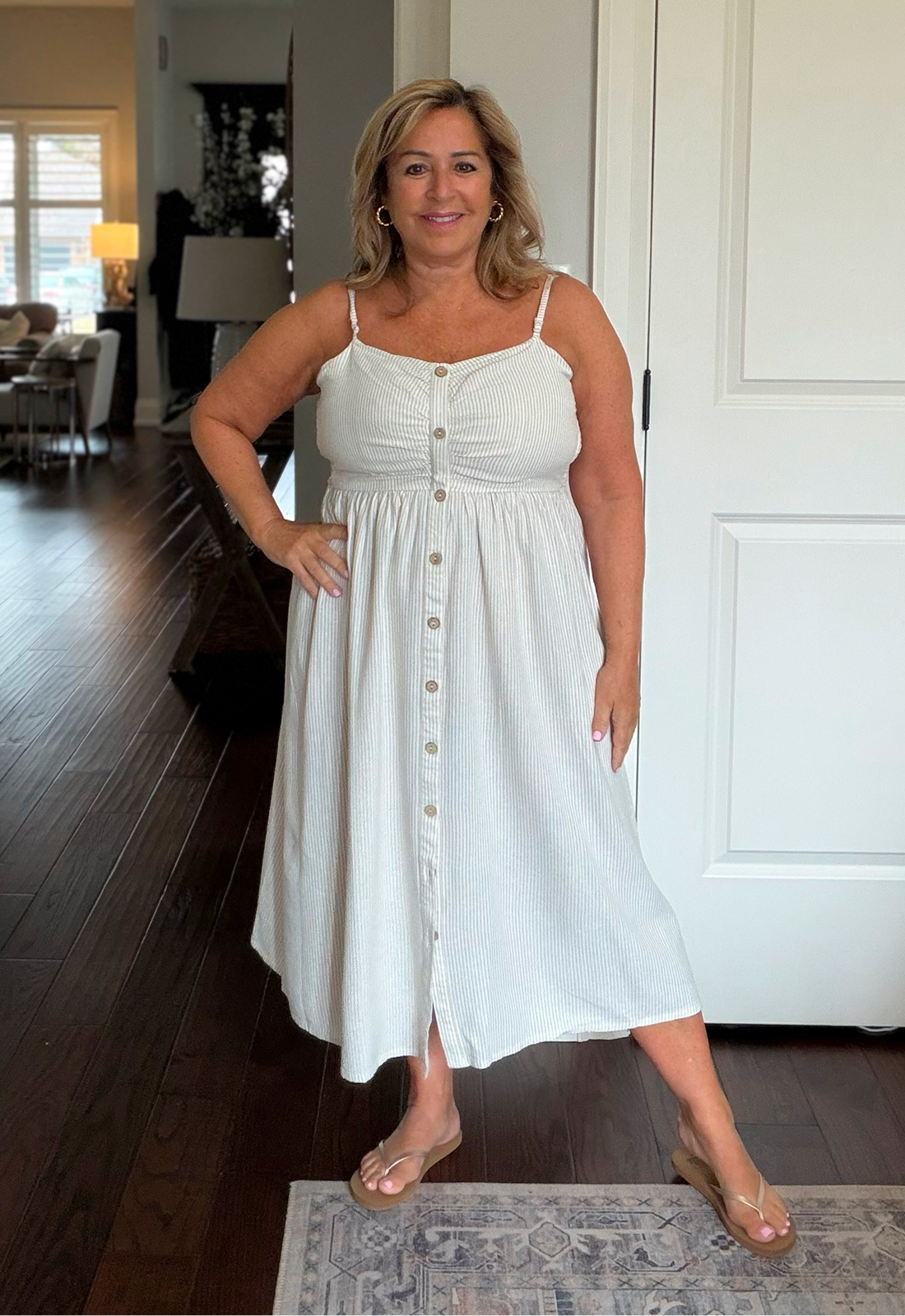 Anita wears the butonned striped dress from Off the Beach brand.