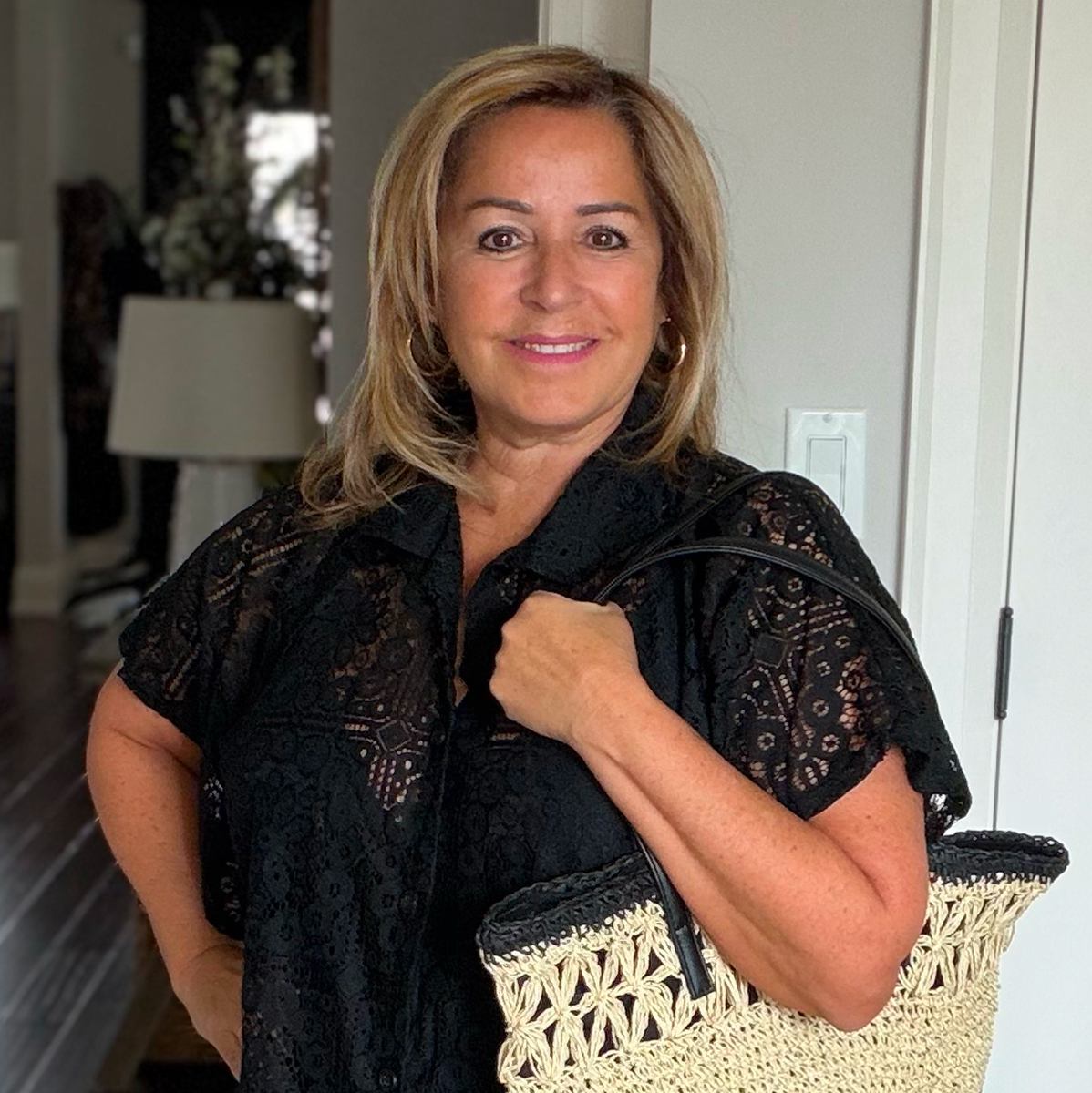 Anita wears the black crochet shirt from Cover Me brand and the crochet beach bag from Sarajane brand.