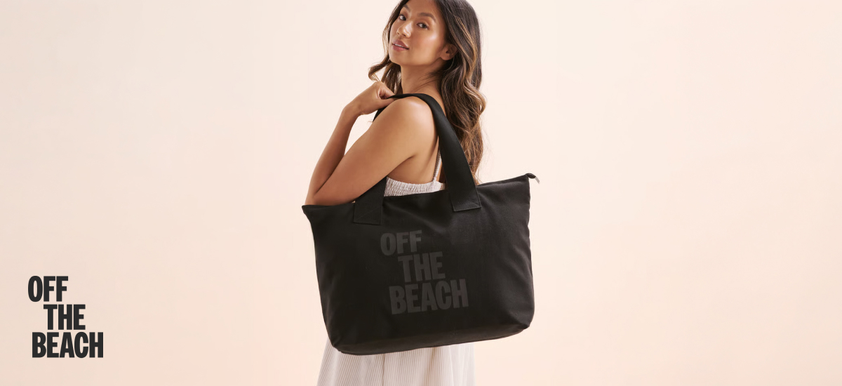 Woman carrying a black Off the Beach bag.