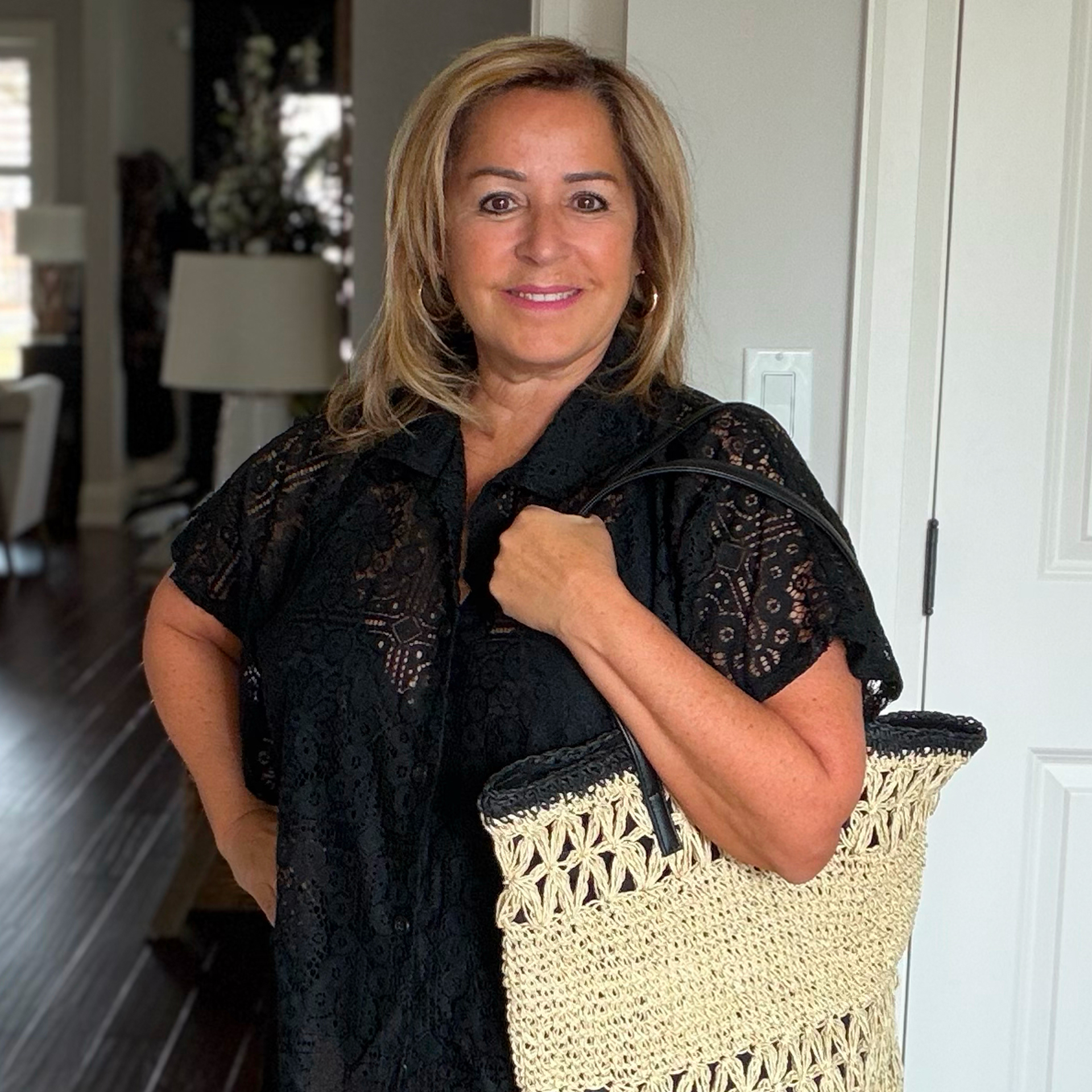 Anita wears the black crochet shirt from Cover Me brand and the crochet beach bag from Sarajane brand.