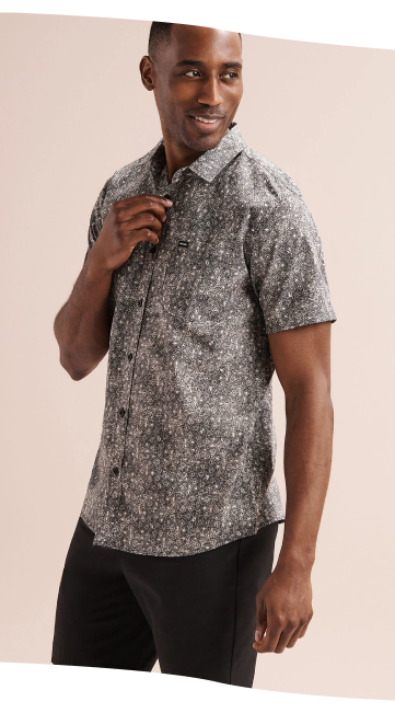 Man wearing a grey retro-patterned shirt by Rip Curl.