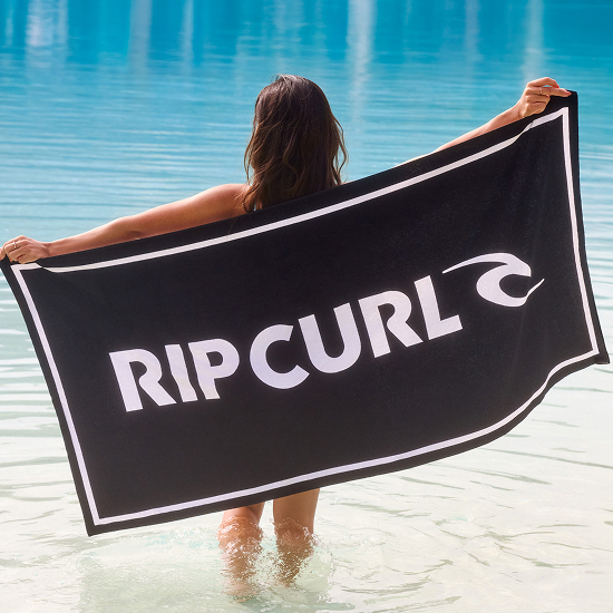 A woman with a beach towel from Rip Curl – Bikini Village 