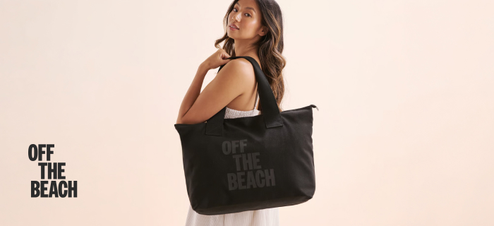 Woman carrying a black Off the Beach bag.