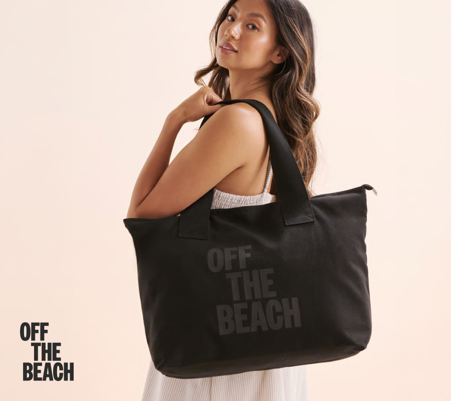 Woman carrying a black Off the Beach bag.