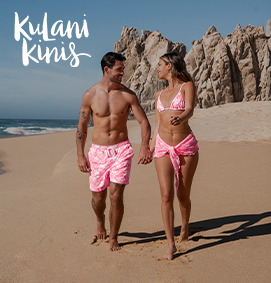 Woman wearing a beach cover-up from Off The Beach in white with beige stripes.